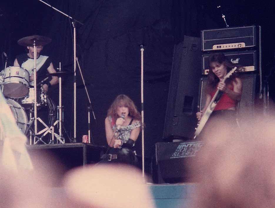 Lee Aaron,Frank Russell and George Bernhardt on stage at the Reading Festival 1983. Photo by Don Murphy ©